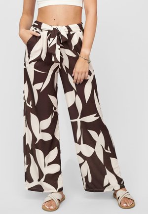 Brown wide-leg pants with a cream leaf pattern, featuring an elastic waistband and a tied belt. Includes side pockets and a soft texture.