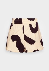 Cotton shorts with an elastic waistband, featuring a cream background and bold black abstract patterns. Distressed hem for a casual look.