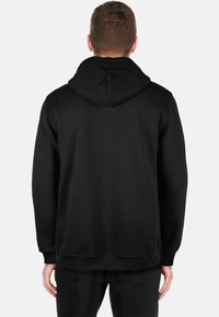 Black hooded sweatshirt featuring a relaxed fit, soft texture, and adjustable drawstring. Stitching detail along cuffs and hem.