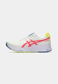 White running shoe with pink and yellow accents. Features breathable mesh upper, padded collar, and a cushioned sole for comfort and support.