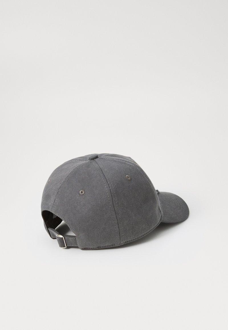 Gray baseball cap with a curved brim, made of textured fabric, featuring a metal adjuster at the back and six ventilation holes.