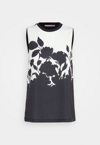 Top senza maniche con un design floreale nero su sfondo bianco, con scollatura rotonda nera e texture del tessuto liscia.