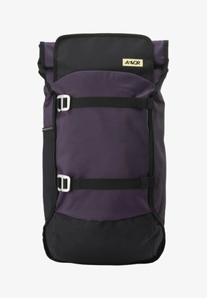 Black and dark purple roll-top backpack with two horizontal adjustable straps and a small rectangular beige logo patch.