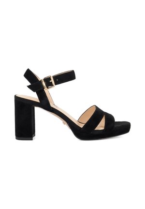 Black suede open-toe heeled sandal with block heel, two front straps, and an adjustable ankle strap with gold buckle.