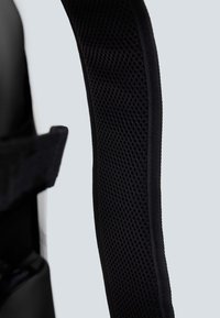 Correa ergonómica negra para el hombro con textura de malla, acolchada para mayor comodidad, que presenta un diseño elegante y bordes reforzados.