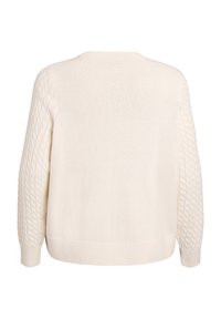 Helekreemjas kudumkangast kampsun tekstuurse teemantmustriga varrukatel, ümara kaelusega ja soonikkoes äärega. Klassikalise kastikujulise lõikega.