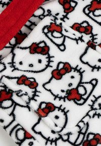 White fleece fabric featuring a repeated pattern of black outlines of Hello Kitty with red bows, accented with red detailing.