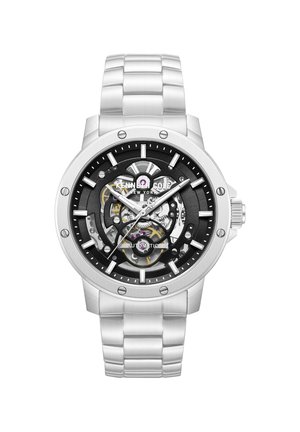 Sølv Kenneth Cole herreur med sort skelet urskive, synlige tandhjul, automatisk urværk og metalledsarmbånd.