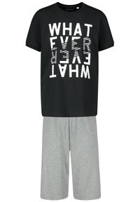 Black t-shirt with bold, reversed white text design, paired with light grey knee-length shorts made of soft fabric.