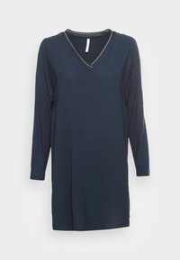 Túnica de mangas longas azul marinho com decote em V. Textura suave e fendas laterais. Decote com acabamento e detalhe de costura em contraste.