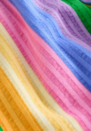 Soft knit fabric with diagonal stripes in green, purple, blue, pink, cream, and orange tones.