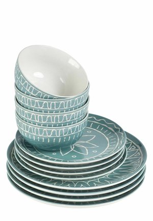 Stack of green ceramic bowls and plates with white decorative patterns on a white background.