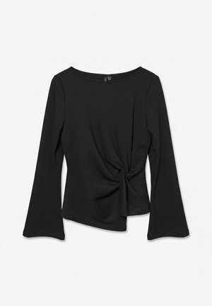 Top noir à manches longues pour femme avec encolure bateau et nœud sur le côté, avec des manches légèrement évasées et un ourlet asymétrique.