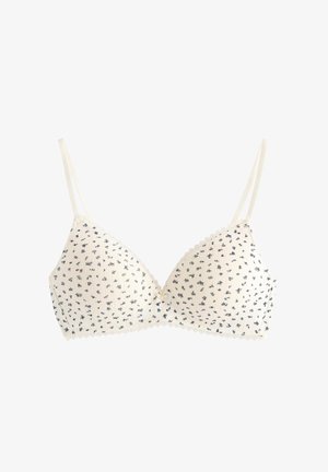 Hvid bralette med navyblåt blomsterprint, struktureret stof og blondekant på kanterne. Har tynde justerbare stropper og en sløjfedetalje i midten.