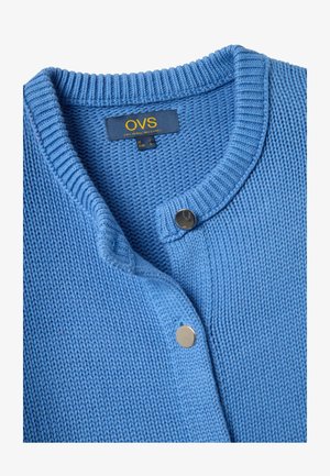Blue knitted cardigan with round neckline and silver snap buttons, labeled OVS size small for Italy and Europe.