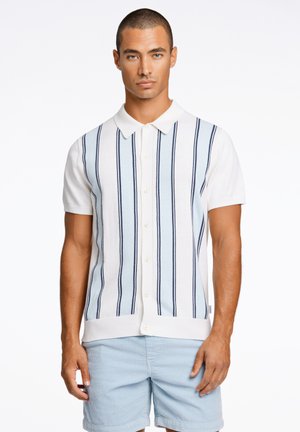 Polo shirt blanc à manches courtes avec des rayures verticales bleu et marine, design à col et fermetures à boutons sur le devant.