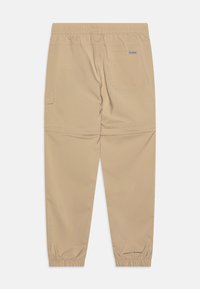Beige cargobyxor med elastisk midja, elastiska manschetter, ett bakfick och sidoficka. Slät textur, lättviktigt tyg, avslappnad design.