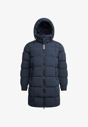 Doudoune bleu marine à capuche, avec un design matelassé, une fermeture éclair à l'avant et des poignets élastiques. Le nom de la marque "JACKIT" est affiché de manière bien visible.