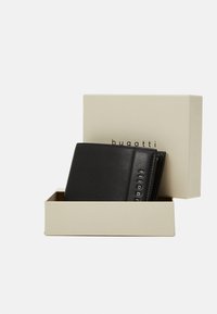 Black leather wallet with textured surface, displayed in beige box featuring "bugatti" branding. Compact, bi-fold design with multiple compartments.