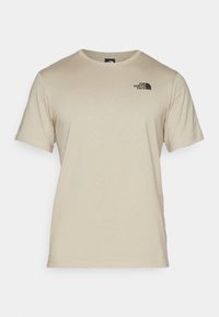 Beige tričko s krátkým rukávem a kulatým výstřihem, s malým černým logem The North Face na levé straně hrudi.