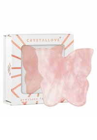 Różowy kwarc w kształcie motyla, kamienny narzędzie do twarzy w białym pudełku z różowymi złotymi akcentami i wzorem w kształcie promieni słońca. Gładka, przezroczysta tekstura.