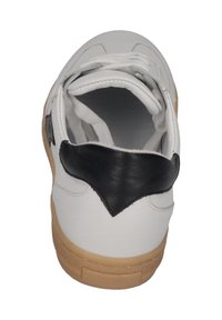 White sneaker with a black leather accent on the heel, featuring a rubber sole and textured laces. Interior shows soft lining.
