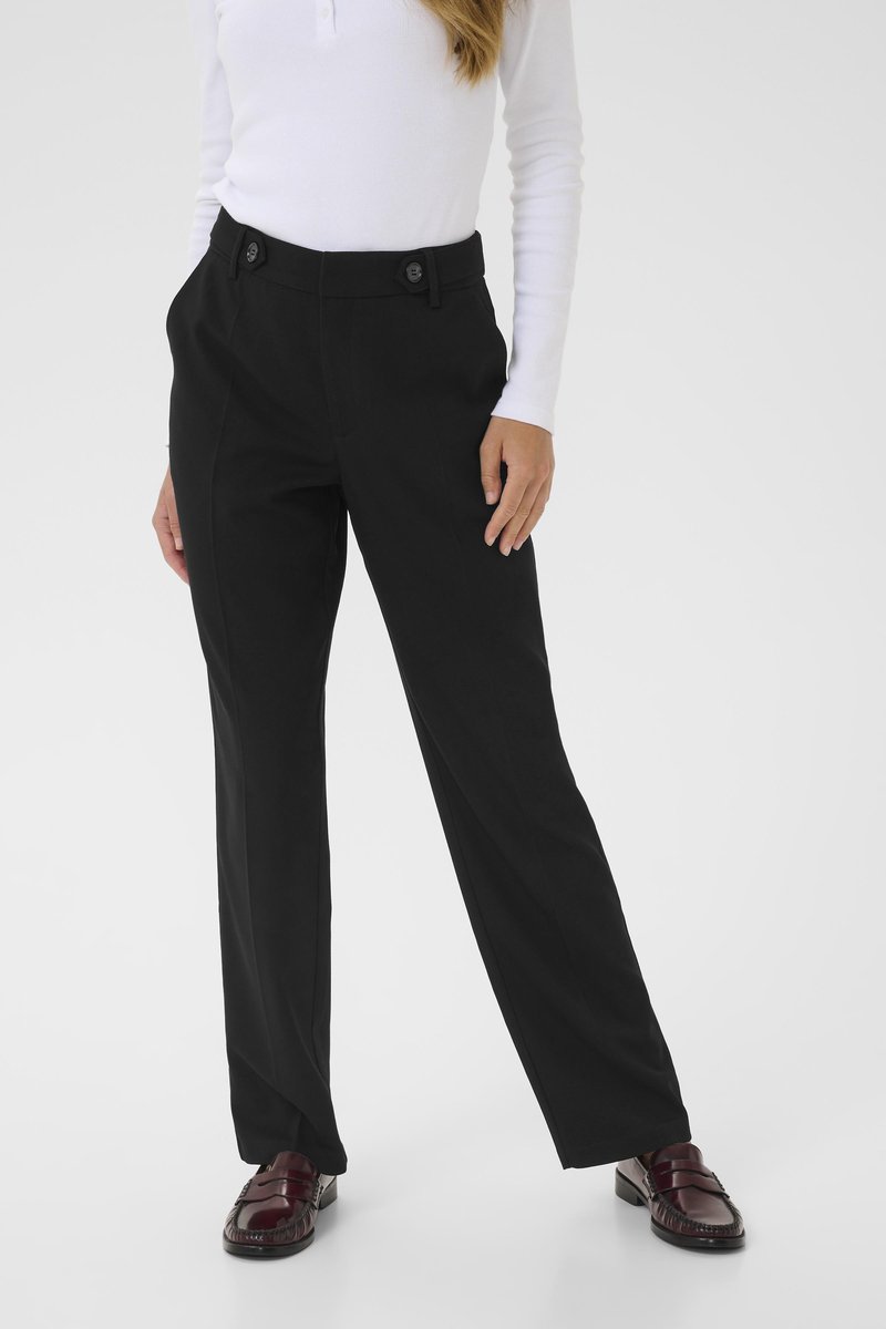 Black tailored trousers with a straight leg design, featuring two front pockets and button closures. Worn with dark burgundy loafers.