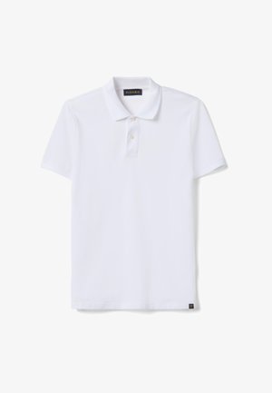 Witte polo met korte mouwen, twee knopen en een kraag, met een klein zwart label aan de onderzoom.