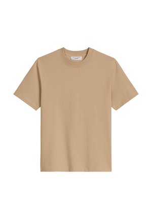 T-shirt beige en coton doux, avec un col rond et des manches courtes, présentant une texture simple et lisse sans motifs visibles.