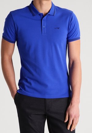 Blue polo shirt with buttoned placket, contrasting collar and sleeve trim. Made of smooth, stretch fabric. Small logo on the chest.