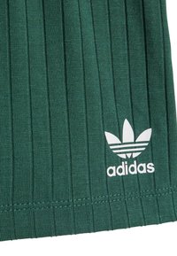 Σκούρο πράσινο υφασμάτινο με κάθετες ρίγες, με λευκό λογότυπο Adidas και γραφικό με τρία φύλλα κοντά στην κάτω αριστερή γωνία.