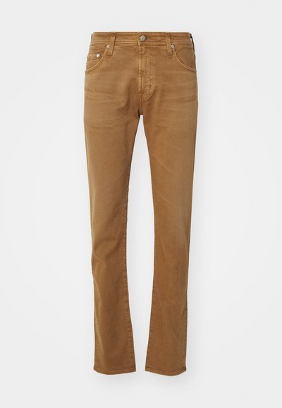 Brune bomulls chinos med en rett snittdesign, fem lommer, metallknapplukking og subtile falminger. Glatt tekstur og slitesterkt stoff.