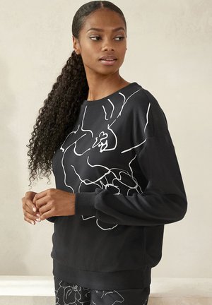 Schwarzer Kapuzenpullover mit einem weißen abstrakten Liniendesign, langen Ärmeln, rundem Ausschnitt und gerippten Bündchen. Weiches Material und entspannte Passform.