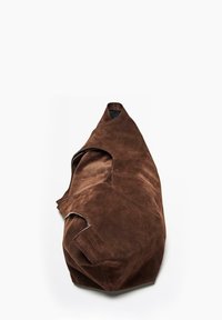 Brown suede bag with soft texture, rounded shape, and cut-out handles. Features visible stitching details and smooth surface.