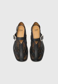 Black synthetic sandals with leather accents, featuring a patterned mesh upper, adjustable buckle, and a rounded toe design.