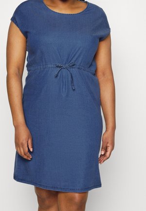 Woman wearing a short-sleeve, knee-length blue dress with a round neckline and a tied waist belt.