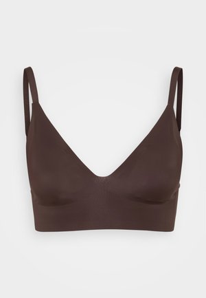 Brown bralette with a deep V-neck, seamless design, and thin adjustable straps. Made from soft, stretchy material for comfort.