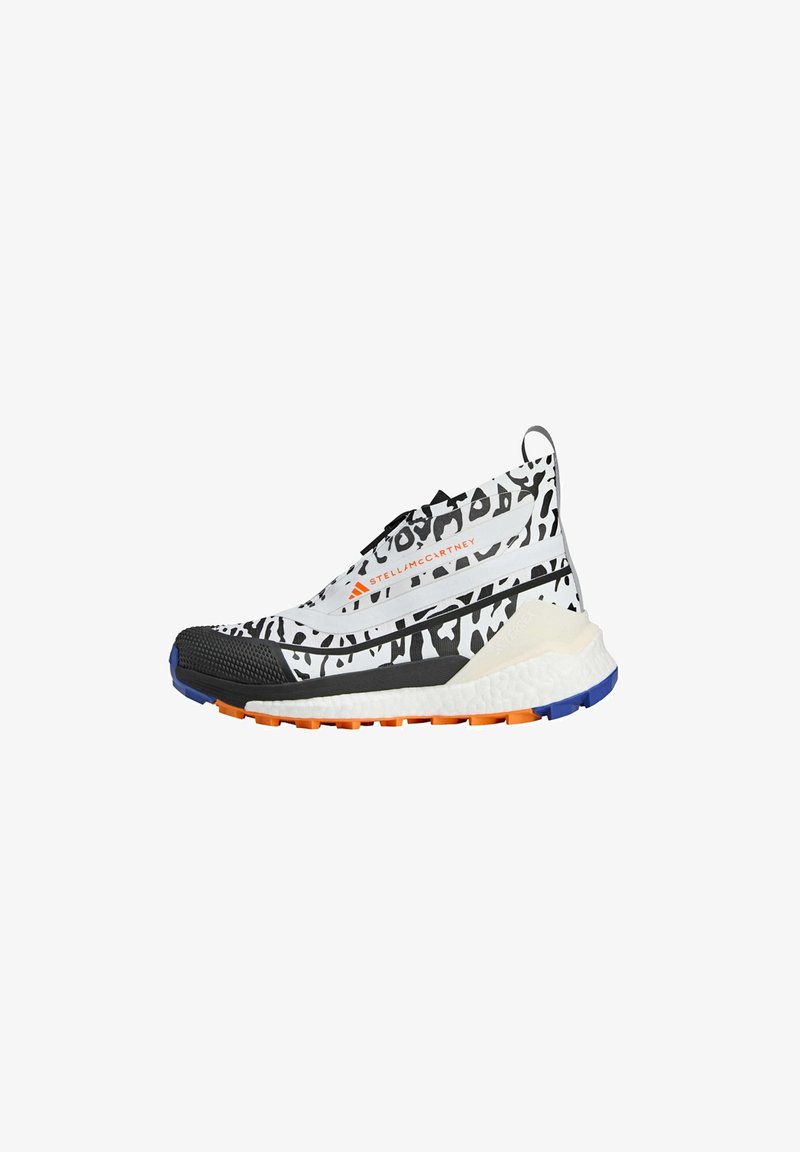 Sport shoe with a black, white, and gray animal print fabric upper, elastic ankle collar, and a textured sole featuring orange and blue accents.