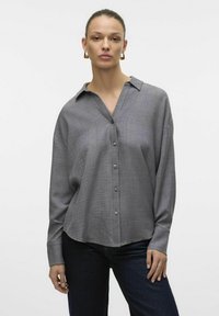 Gray button-up shirt with a textured fabric, long sleeves, and a collar. Features a relaxed fit and front button closure.