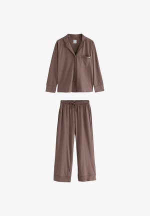 Braunes Schlafanzugset bestehend aus einem knopfbaren Langarmoberteil mit Tasche und passenden Hosen mit elastischem Bund und weitem Bein. Hergestellt aus weichem Material.