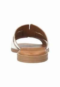 Leather slide sandal with a low, flat tan sole. Metallic silver upper features a cut-out design, showcasing a smooth texture and minimalist style.