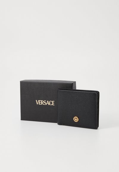 Black leather wallet with a textured finish, featuring a gold-tone emblem and presented in a black box with "VERSACE" embossed in gold.