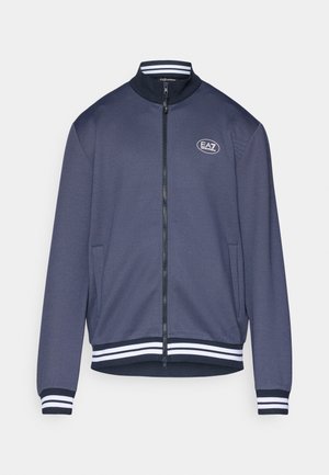 Navy blue zip-up jacket with a textured finish, ribbed white-striped cuffs and hem, and a small EA7 logo on the chest.