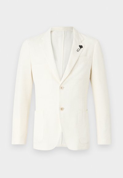 Kreemikaalune bleiser tekstureeritud kangast, millel on kaks esist taskut, üks ventilatsiooniauk, kaks nuppu ja must kraepin.