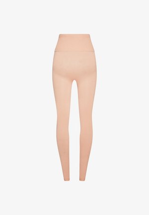 Högmidjade, ljusbeige stickade leggings med en bred ribbad midja, visade platt mot en vit bakgrund.