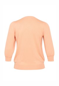 Jasnopomarańczowy sweter z miękkiej dzianiny, z rękawami w kształcie balonów i okrągłym dekoltem. Prosty design bez ozdób.