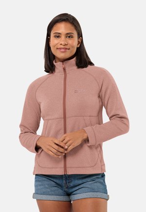 Veste zippée rose clair avec une surface texturée, dotée d'un col haut et de deux poches avant. Manches courtes avec trous pour les pouces.