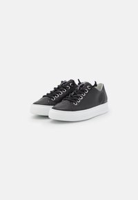 Black leather sneakers with white rubber soles, rounded toes, metal eyelets, and black laces. Smooth texture without patterns.