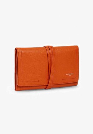 Orange leather wallet with a smooth texture, fold-over design, and a decorative strap. Features subtle embossed branding on the front.