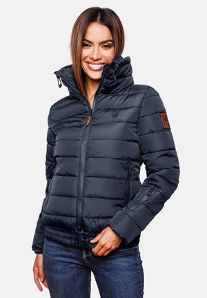 Navy puffer jacket with a high collar, horizontal quilting, adjustable hem, and zippered pockets; features a leather logo patch on the sleeve.